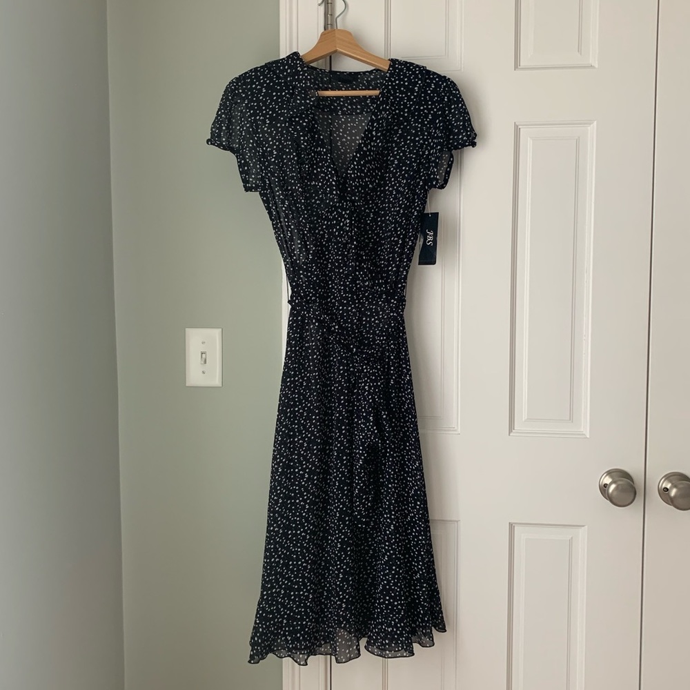 Black polka dots wrap ruffles dress. Sheer fabric.